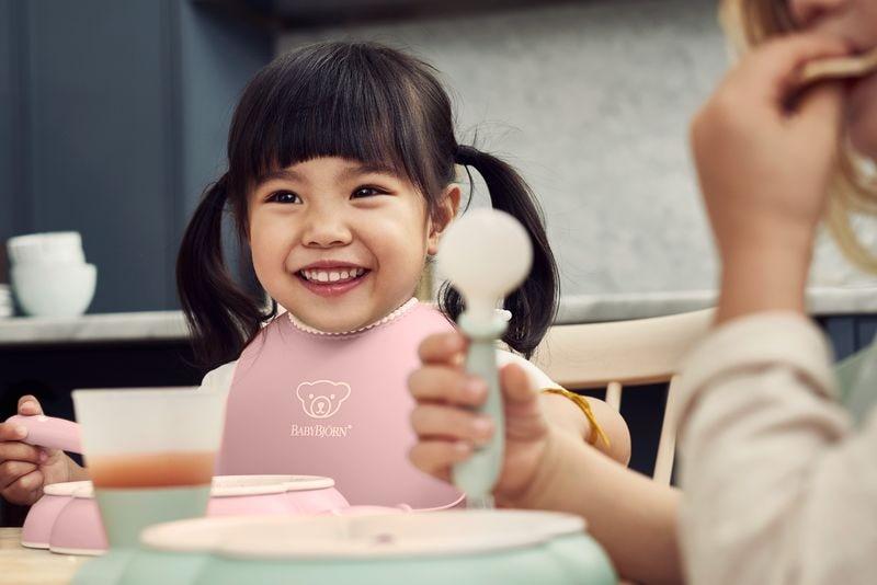 toddler with bib eating